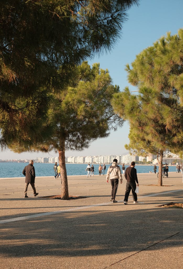 People enjoying a leisurely walk along the beautiful seafront in Thessaloniki, Greece.